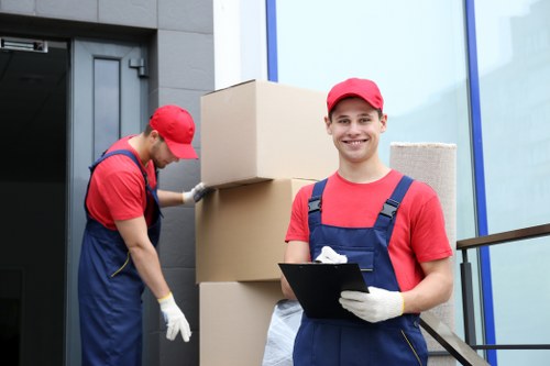 Student removals service in Claphampark with packed boxes and moving van